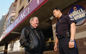 Ivan Chu, of the New Westminster Police, chats with the former owner of the College Place Hotel, Jack Butterworth, who recently sold the establishment to the provincial government who will convert it to low income housing. Chu says when the pubs in the hotel were open they were a considerable drain on the force’s resources, especially at closing time.